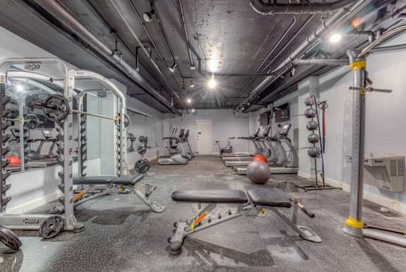 A gym with a variety of equipment including a leg press machine.at Iris Luxury Apartments, Tennessee