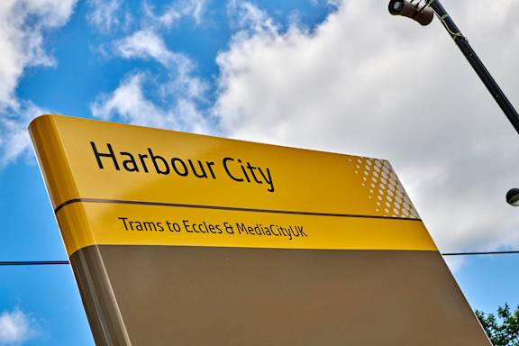 A yellow sign for Harbour City with black text.
