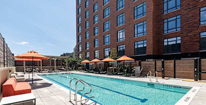 A pool with a white and blue border and a white and black border with the words