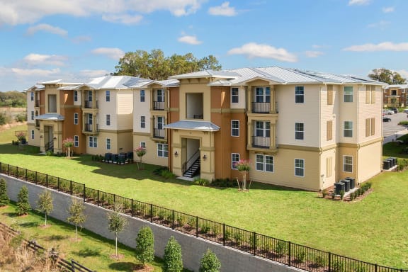 an aerial view of an apartment building on a green lawn