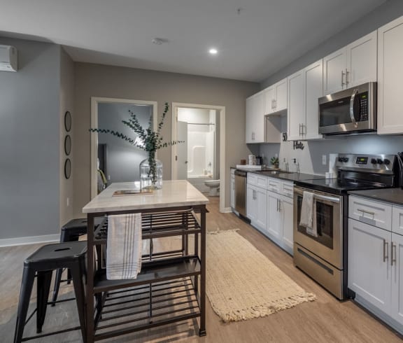 a kitchen with stainless steel appliances and a wooden table
