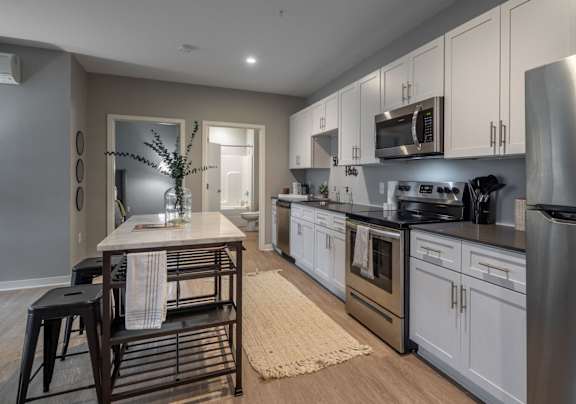 a kitchen with stainless steel appliances and a wooden table