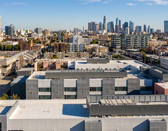 A cityscape with a clear blue sky above it.