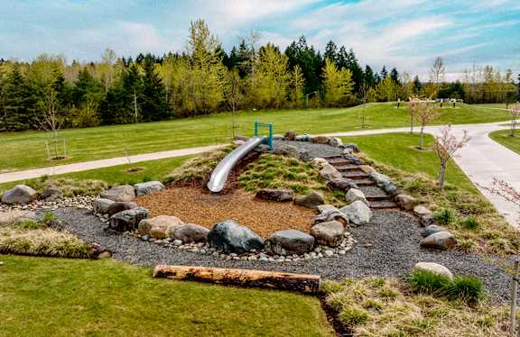 a playground with a slide in a park
