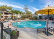 Thumbnail 24 of 41 - Poolside Seating at Northgreen at Carrollwood Apartments in Tampa, FL