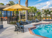 Thumbnail 25 of 41 - Poolside Seating at Northgreen at Carrollwood Apartments in Tampa, FL