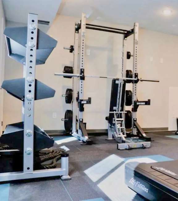 A well-equipped gym with a variety of machines and weightlifting equipment.
