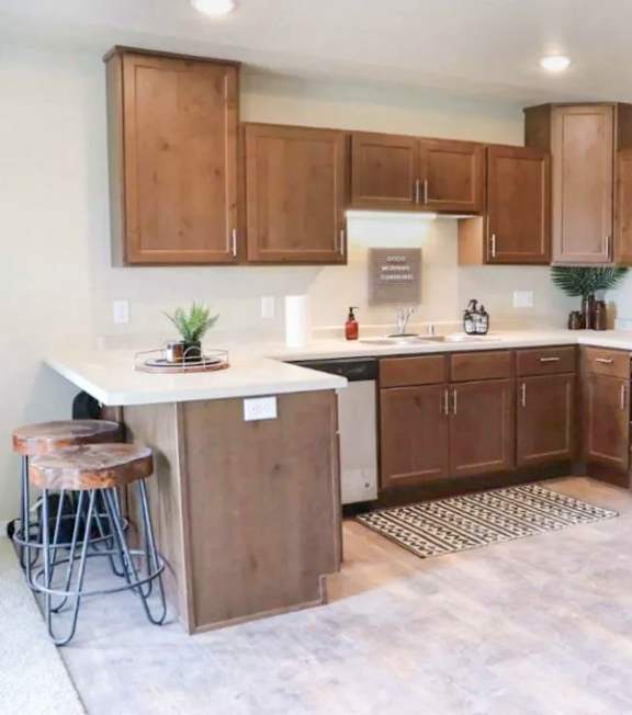 A kitchen with wooden cabinets and stainless steel appliances.