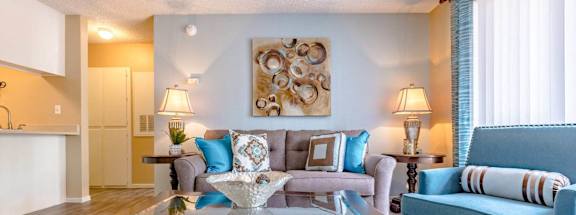 A living room with a blue couch and a coffee table.