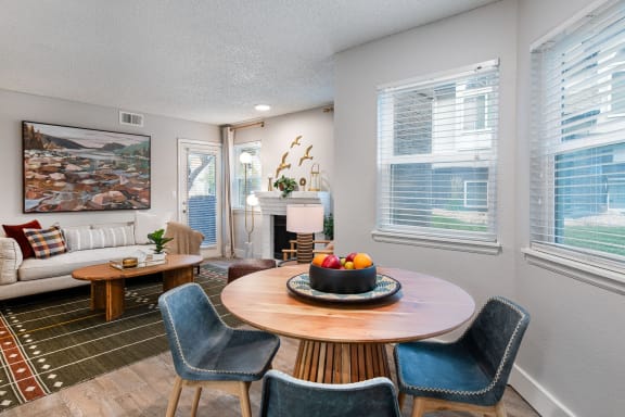 a living room with a table with a bowl of fruit on it