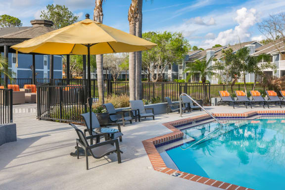 Poolside Seating at Northgreen at Carrollwood Apartments in Tampa, FL