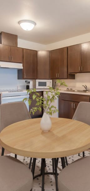 a kitchen and dining area with a table and chairs and a refrigerator