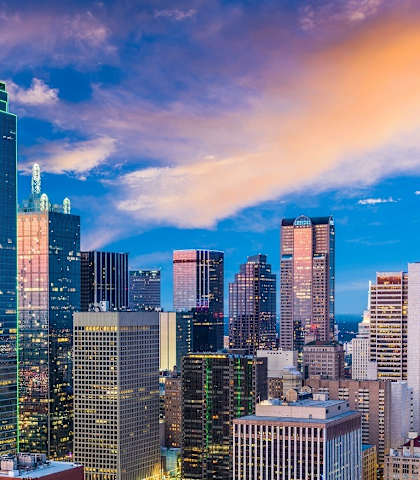 the skyline of the city at dusk