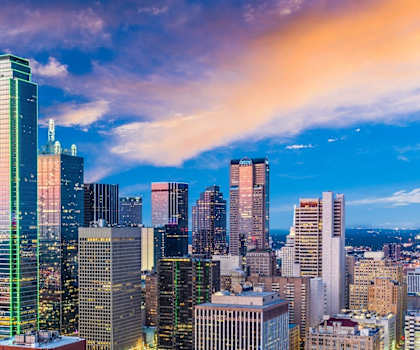 the skyline of the city at dusk