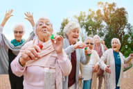 a group of elderly women blowing bubbles