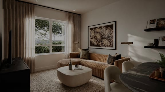 A living room with a large window, a sofa, a coffee table, and a TV.