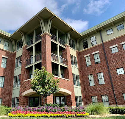 a large brick building with a tree in front of it