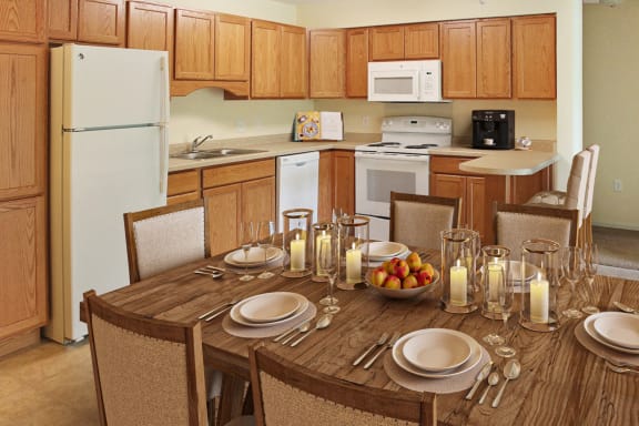 a kitchen and dining room with a table and chairs