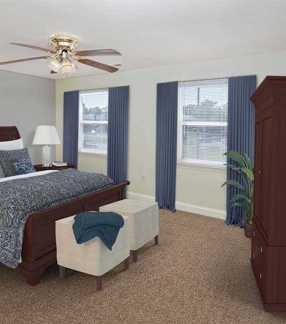 A bedroom with a bed, nightstand, and a ceiling fan.