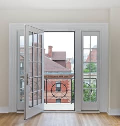 a bedroom with a bed and a large window