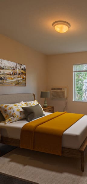 a bedroom with a bed and a desk in it