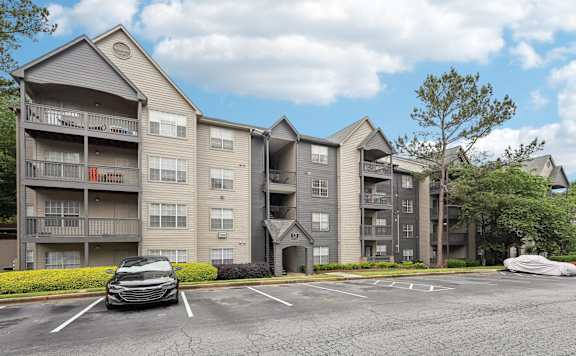 A parking lot in front of apartment buildings.