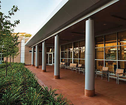 A long row of chairs are lined up under a covered walkway at Hummingbird Pointe & The Gardens, Parma, 44129