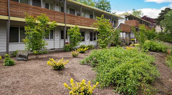 A building with a garden in front of it.