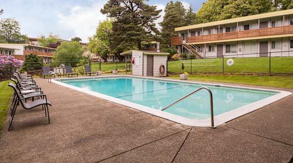 A rectangular pool with a metal ladder on the side.