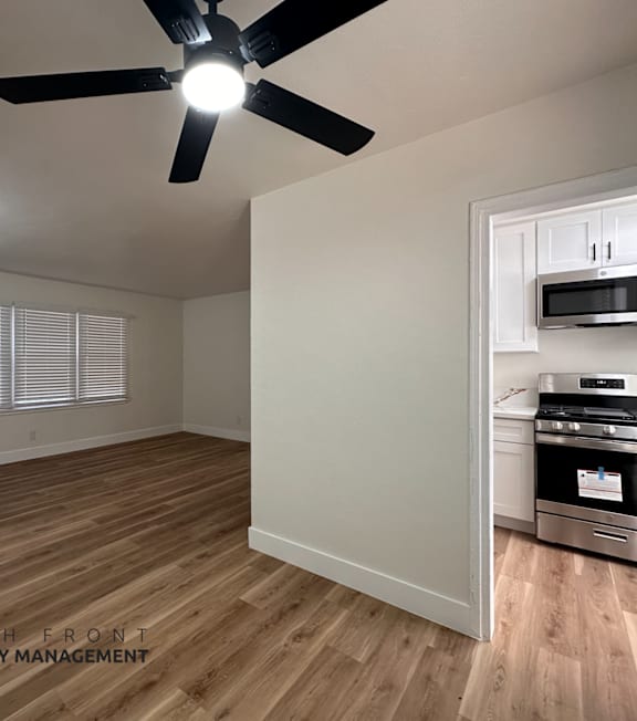 A well-lit, modern kitchen and living room with a dining area.