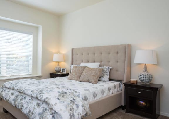 a bedroom with a bed and a window