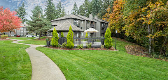 a house with a yard and a sidewalk in front of it