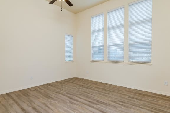 Living Room with three large windows and a ceiling fan.