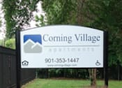 Thumbnail 4 of 7 - A sign for Corning Village Apartments with a phone number and website.