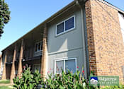 Thumbnail 6 of 7 - A building with a sign that says Ridgecrest Apartments.