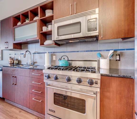 a kitchen with stainless steel appliances and wooden cabinets
