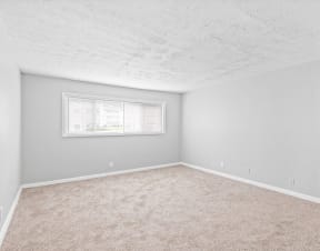 an empty room with carpet and a window at Uphill Flats, Decatur, GA, 30032