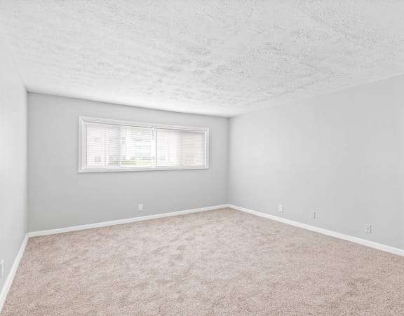 an empty room with carpet and a window at Uphill Flats, Decatur, GA, 30032