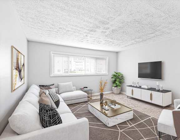 a living room with a couch and a tv at Uphill Flats, Decatur