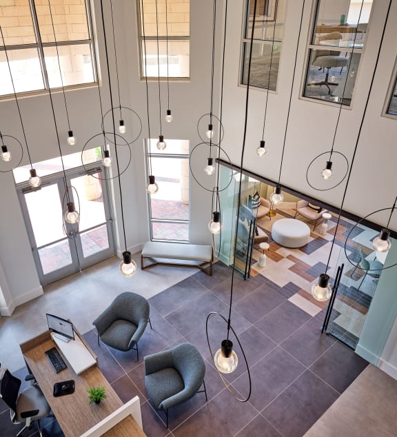 arial view of an office lobby with chairs and desks and lights
