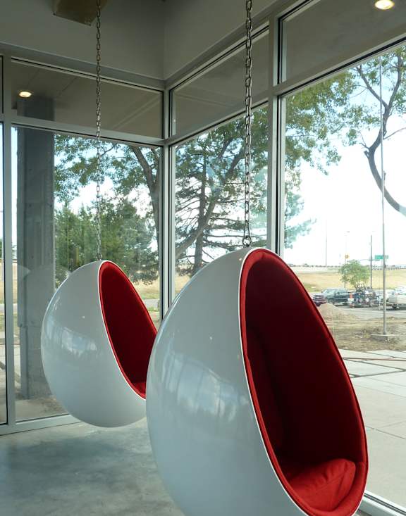 A gym with a variety of equipment including treadmills, weights, and exercise machines.