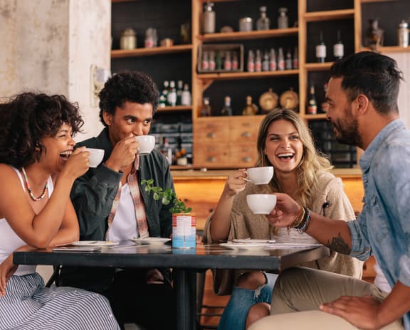 people sitting at a table drinking coffee