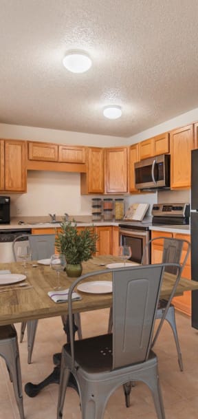 a kitchen with a table and chairs and a refrigerator