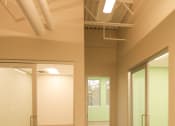 Thumbnail 5 of 8 - an empty room with glass doors and white walls