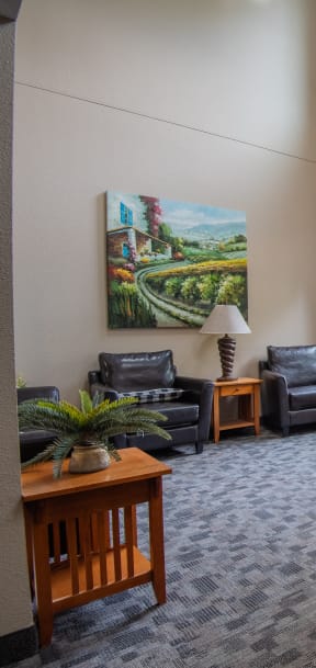 a lobby with an exit door and chairs and a table