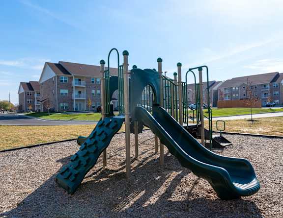 a playground with a slide at Sandstone Court Apartments, Greenwood, IN