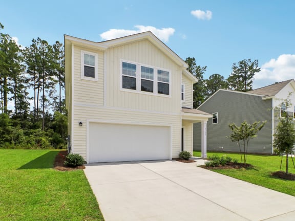 a kitchen with white cabinets and a granite counter top at Beacon at Ashley River Landing, Summerville, SC