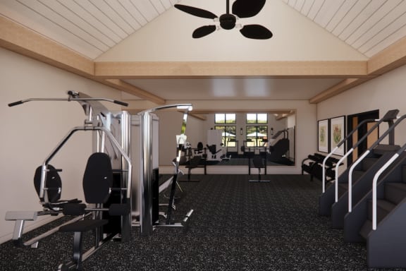 A gym with a variety of equipment including a treadmill, weights, and a bench press. at Sandhill Parkway Townhomes Apartments, East Bethel, Minnesota