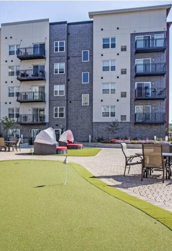 a putting green in front of an apartment building at Apex 41, Lombard, IL, 60148