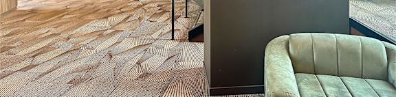 a lobby with a couch and a wall with two leaves on it